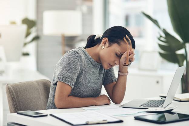 A person sitting at a desk with her head in her hand

AI-generated content may be incorrect.